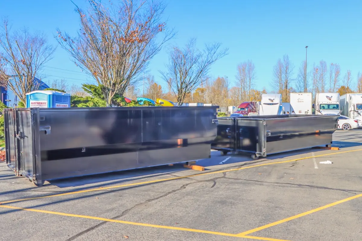 Professional dumpster rental service with roll-off container on residential driveway in San Bernardino
